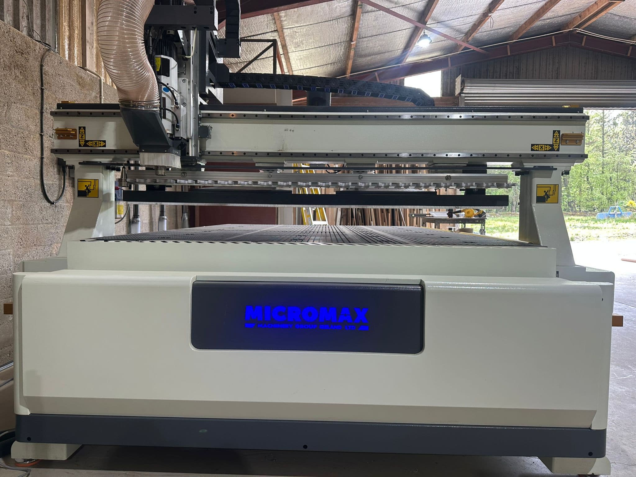 Micromax 2030 L ATC in daylight Micromax 2030 L ATC CNC router with illuminated branding in a daylit workshop